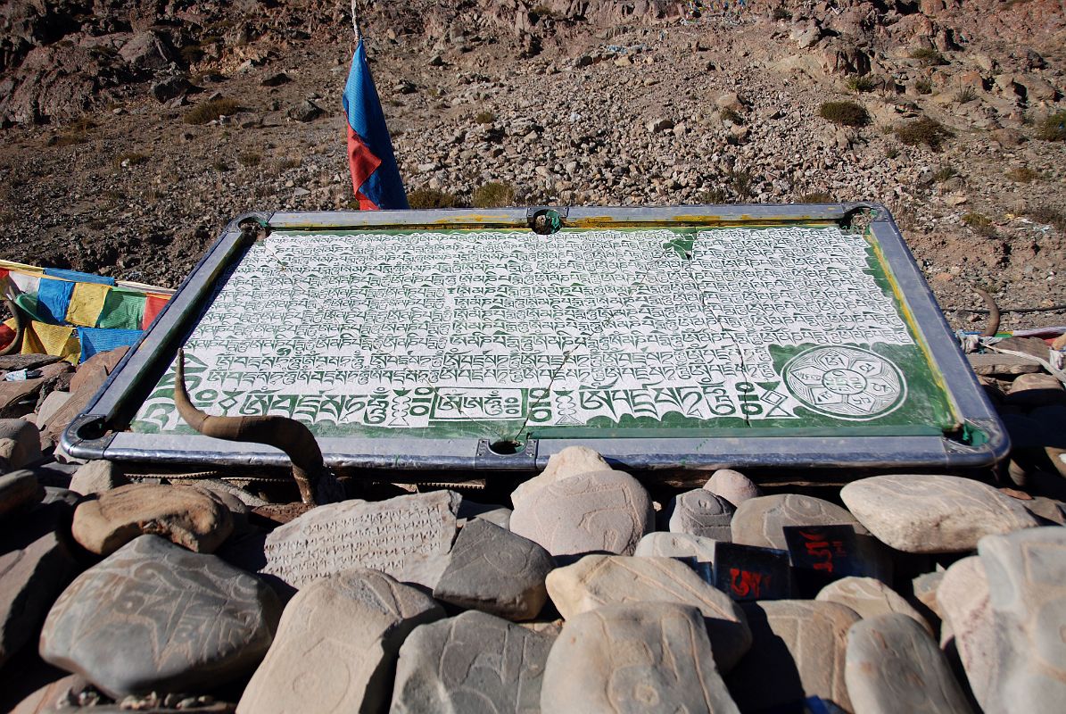 43 Mani Wall In Darchen Tibet Has A Mani Pool Table I walk up the main street of Darchen to a mani wall on the northern edge of town. This mani wall had a few pool tables modified to a more religious perspective � very creative.